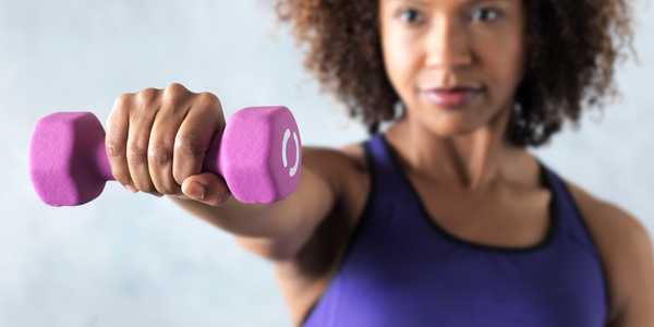 A woman exercising with a dumbbell.